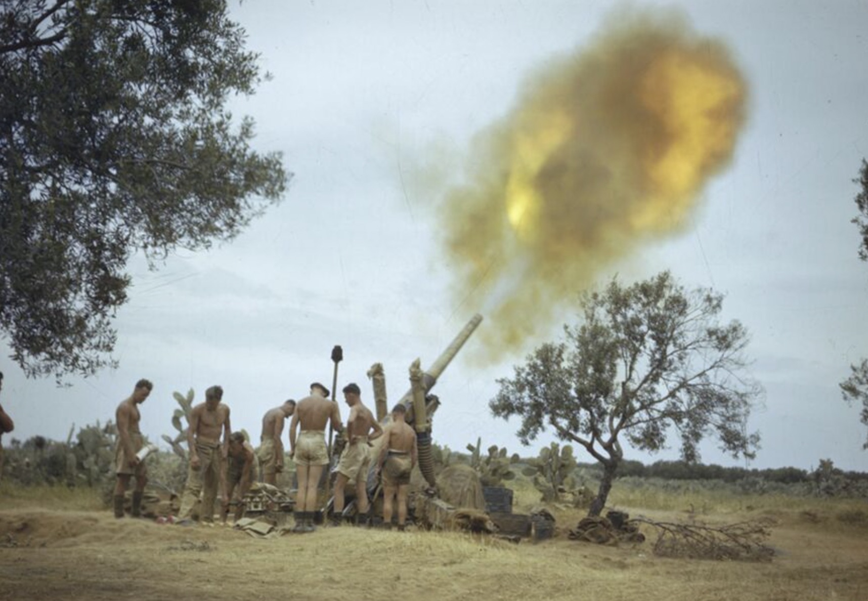 Soldiers of the Eighth Army in Tunisia fire a gun four miles from the enemy lines 